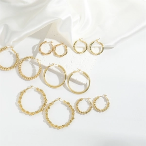 Set of gold hoop earrings featuring twisted, beaded, and hammered metal textures