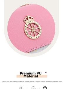 Detail of pink faux leather bag with crosshatch texture and gold crown emblem