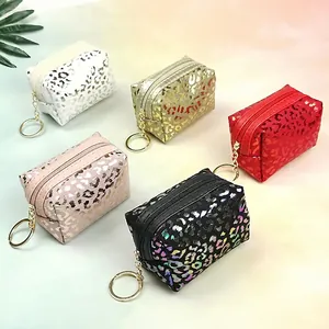 Set of five glitter leopard print mini coin purses with gold keychains in various colors