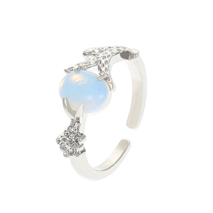 Silver bow adjustable ring with oval light blue opal gemstone on white background