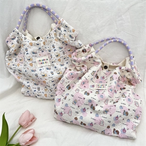 Detailed view of quilted bubble fabric tote bags with cute cartoon dog prints and woven handles