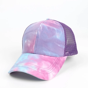 Detail of tie-dye ponytail trucker hat with purple mesh back and adjustable opening