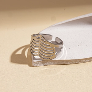 Macro detail of silver hollow cutout ring with rib-like texture on stone display
