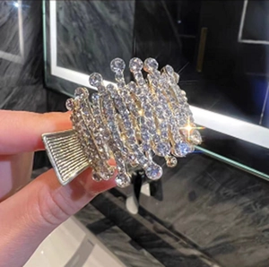 Macro detail of high ponytail hair clip with sparkling rhinestones and alloy spring