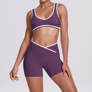 Detail of high-waist yoga set featuring a V-shaped crossover waistband and purple contrast trim