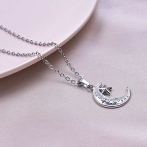 Macro shot of silver crescent moon and star pendant with 18k plating on soft velvet