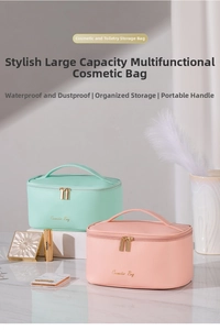 Close-up of pink and mint green cosmetic bags with dual zippers and gold hardware