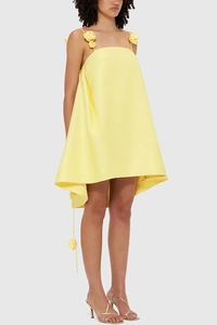 Detail of yellow satin mini dress featuring three delicate 3D handmade floral strap accents