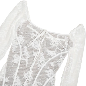 Detail of white lace dress featuring retro square neckline and delicate front tie-up ribbon