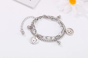 Detail of silver double-layered stainless steel bracelet with hollow star pendants