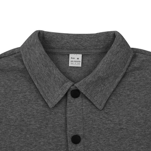 Detailed view of dark grey jacket collar with black button and size M fabric label