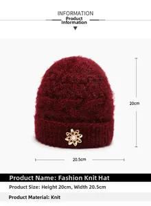 Detail view of burgundy knitted winter hat with pearl flower showing 20cm height dimension