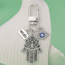 Detailed silver Hamsa hand keychain with blue Evil Eye and Wish pendant on metal ring