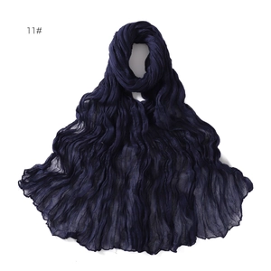 Detail shot of navy blue pleated scarf with lightweight breathable linen cotton texture