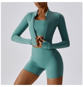 Detailed view of sage green yoga set featuring zipper jacket with thumbholes and high waist shorts