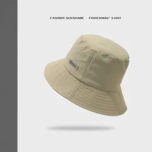 Foldable beige sun bucket hat for women with quick-dry fabric and side brand label