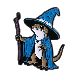 Cute lizard wizard enamel pin with blue magic hat and staff on white background