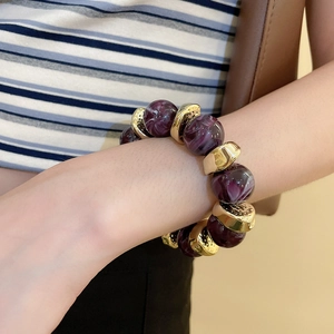 Detailed view of purple marble acrylic beads with gold textured metallic spacers on bracelet
