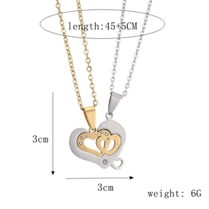Detail of silver and gold puzzle heart necklaces with Love engraving and small crystals