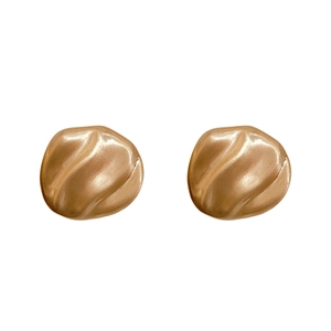 Minimalist gold pleated geometric stud earrings with irregular texture and matte finish