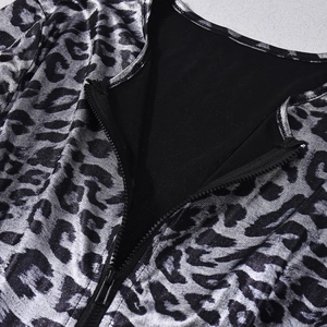 Macro detail of silver leopard print fabric with V-neck zipper and metallic coating texture