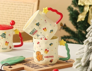 Detail of stacked Christmas ceramic mugs featuring gingerbread patterns and candy cane handles