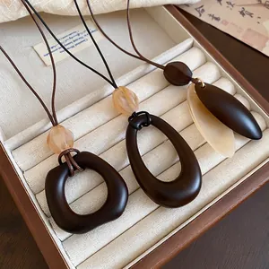 Modern geometric resin and wood style pendant necklace with artistic earth tones