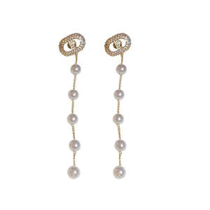 Elegant gold pearl drop earrings with sparkling zircon studs on a clean white backdrop