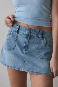 Close-up of light blue high-waisted denim skirt with double buttons and front pockets
