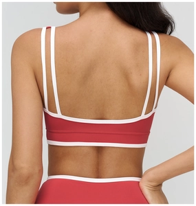 Back view of red yoga bra with white contrast piping and double thin shoulder straps