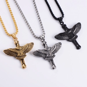 Detailed view of titanium steel eagle pendants in gold, silver, and black box chains