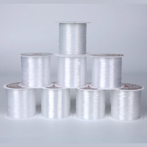 Stack of 0.45mm transparent non-elastic crystal string rolls for DIY jewelry beading