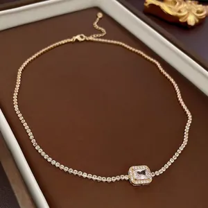 Elegant gold tennis necklace featuring a square zircon pendant in a luxury display case