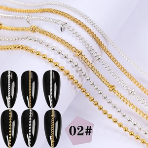 Detailed view of silver and gold metal nail art chains with pearl and rhinestone accents