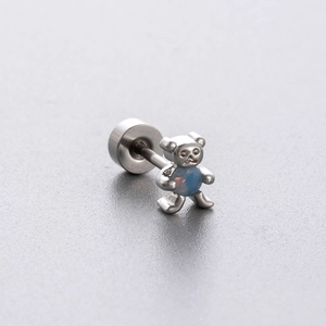 Silver bear stud earring in titanium steel with a blue gemstone on light background