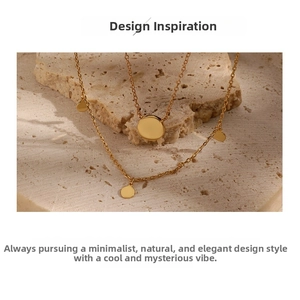 Detail view of a gold geometric round disc pendant necklace on a natural stone base