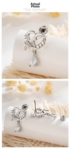 Detail of silver heart bow earrings with drop zircon and threaded screw back closure