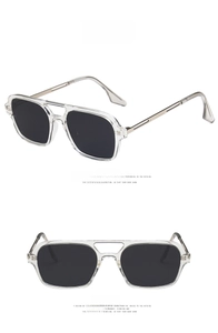 Detail of transparent square sunglasses featuring a double bridge and grey lenses
