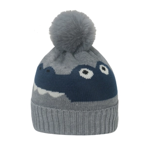 Detail of grey knitted baby hat with blue stripes and cartoon dinosaur pattern