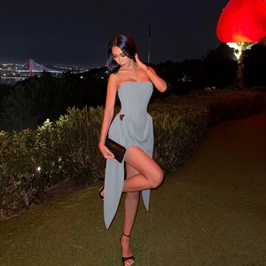 Detail of grey-blue strapless dress featuring a high side slit for an elegant evening look