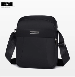 Close-up of waterproof black oxford fabric and metal logo plaque on the shoulder bag