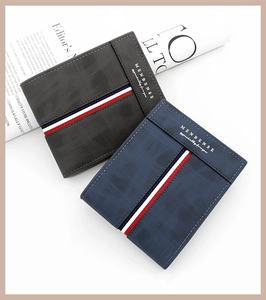 Detail of matte men's trifold wallet with tri-color webbing and metallic logo finish