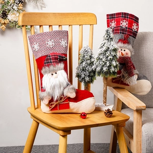 Gemütliche Szene mit Weihnachtssocken (Weihnachtsmann und Schneemann) auf Holzstuhl
