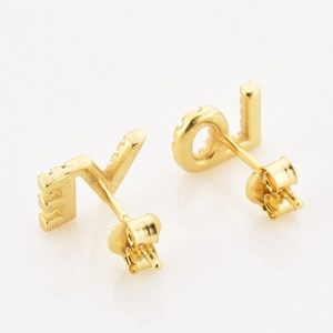 Detailed macro shot of gold plated S925 silver LOVE letter earrings with tiny crystals