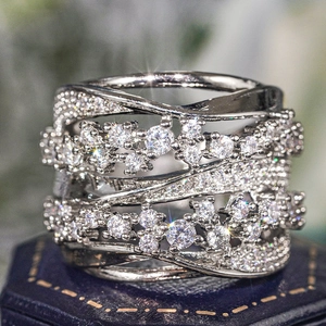 Macro shot of silver-tone wide multi-layer crisscross ring with pavé-set zircon crystals