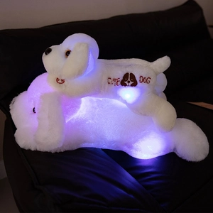 Luminous plush puppy toy with LED glowing effect and cute dog embroidery on sofa