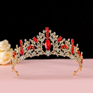 Detailed close-up of Baroque gold crown featuring ruby red gemstones and floral patterns