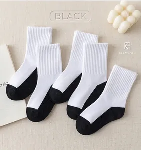 Detail of white cotton crew socks with reinforced black heel and toe in five-pair pack