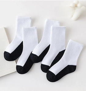 Detail of white cotton crew socks with reinforced black heel and toe in five-pair pack
