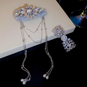 Close-up of velvet bow hair clip with rhinestones, metal chains and faux pearls